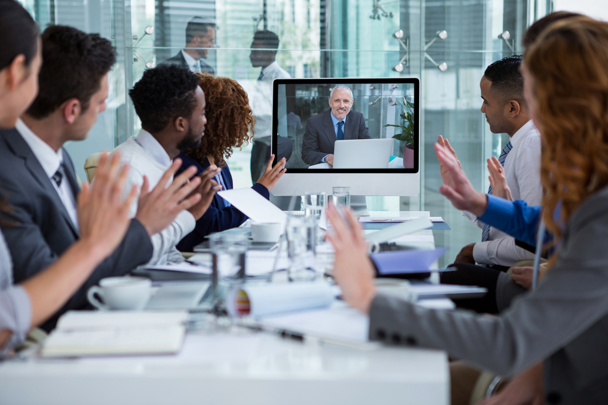 Business people looking at a screen during a video conference in the office